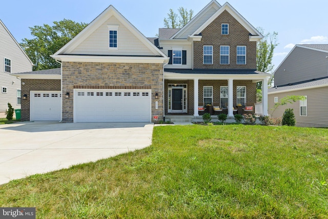 craftsman house featuring covered porch, a front yard, and a garage