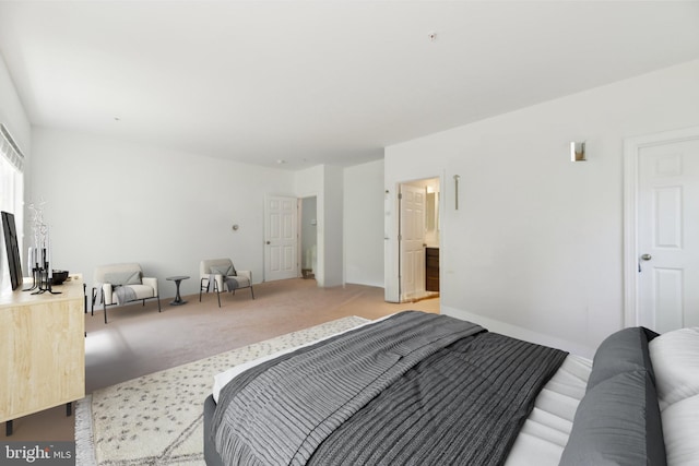 carpeted bedroom with ensuite bath