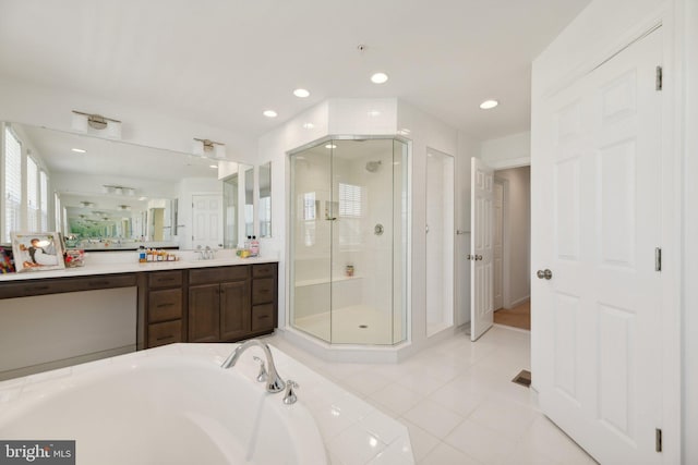 bathroom featuring tile patterned flooring, vanity, and plus walk in shower