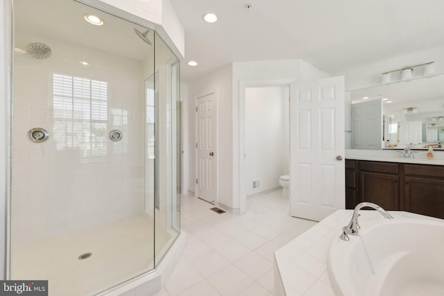 full bathroom with tile patterned floors, toilet, vanity, and shower with separate bathtub