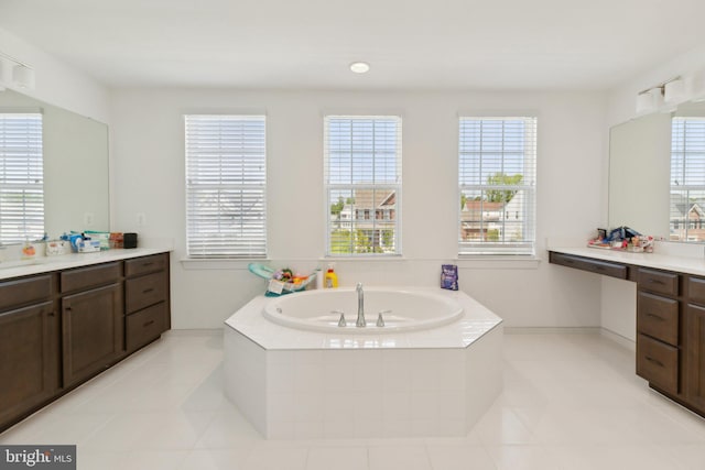 bathroom featuring tile patterned floors, tiled tub, and vanity