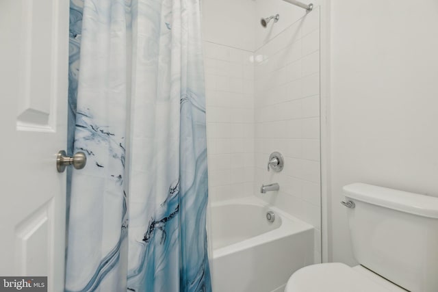 bathroom with toilet and shower / tub combo with curtain