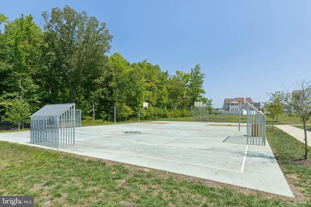 view of community featuring basketball court and a lawn