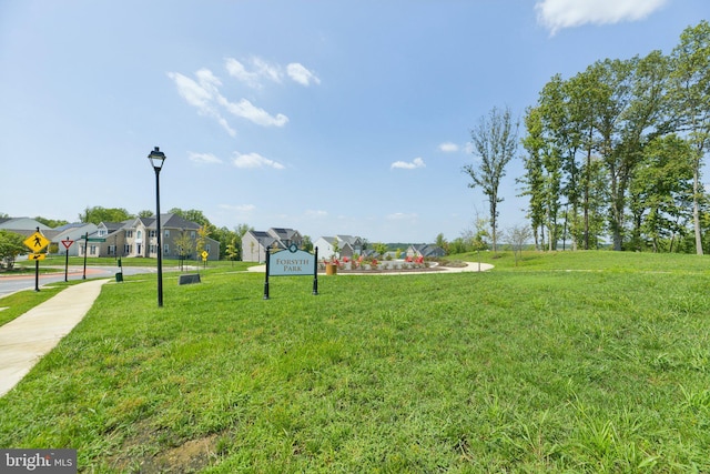 view of home's community featuring a lawn