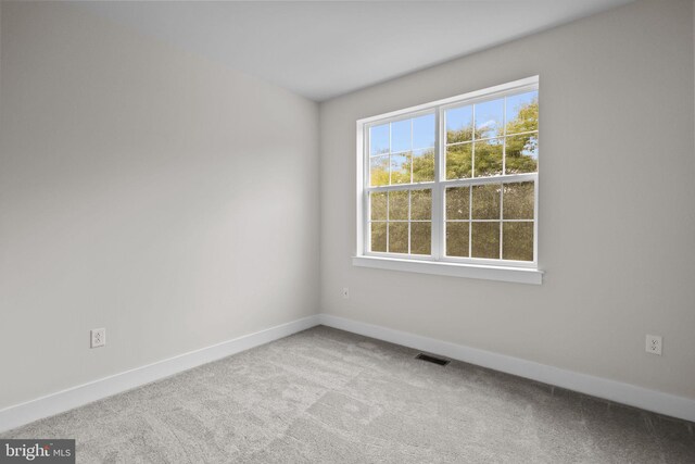 empty room featuring light carpet