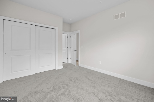 unfurnished bedroom featuring carpet and a closet