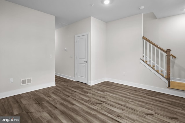 empty room with dark hardwood / wood-style floors