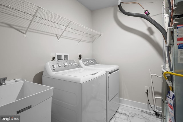 laundry room with independent washer and dryer and sink