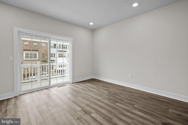 empty room with hardwood / wood-style floors