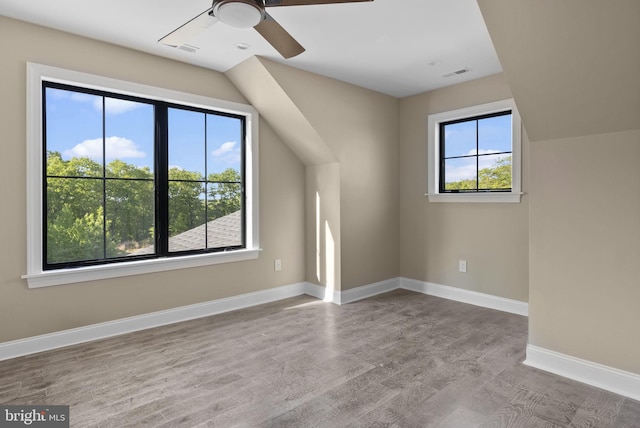 additional living space featuring ceiling fan and a wealth of natural light