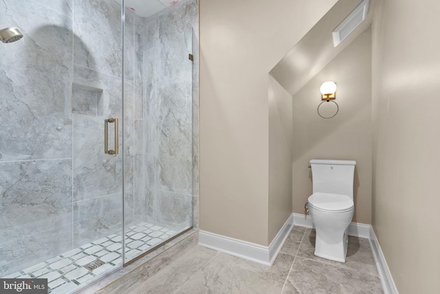 bathroom with a shower with shower door and toilet