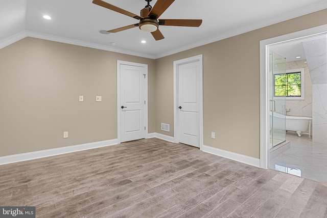 unfurnished bedroom with light wood-type flooring, vaulted ceiling, ceiling fan, crown molding, and connected bathroom