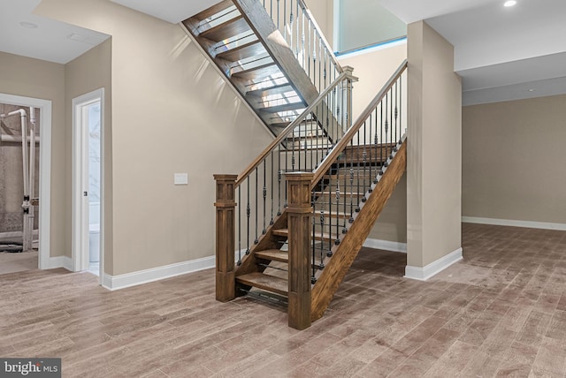 staircase with hardwood / wood-style flooring