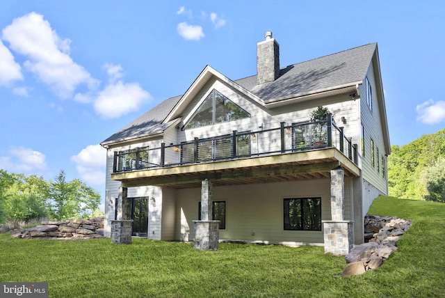 rear view of property with a lawn and a deck