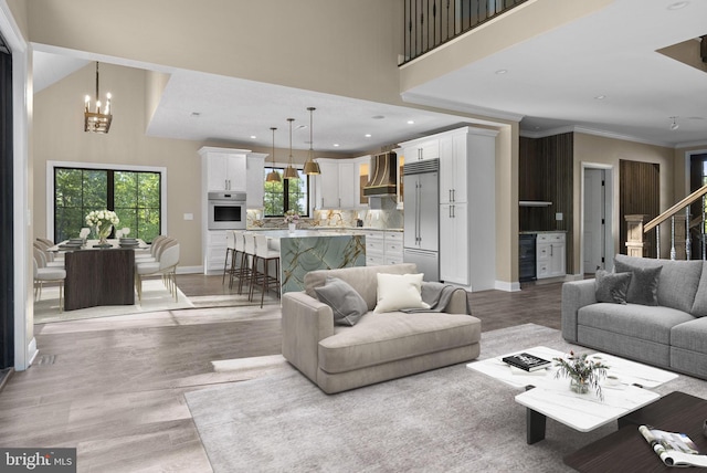 living room with a chandelier and light hardwood / wood-style floors