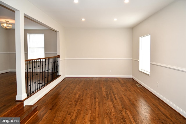 unfurnished room featuring dark wood-type flooring