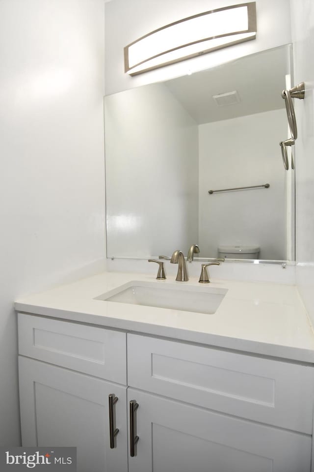 bathroom with vanity and toilet