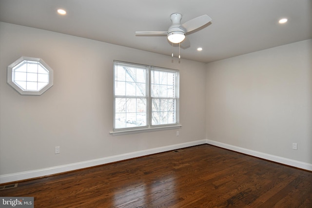 unfurnished room featuring dark hardwood / wood-style floors and ceiling fan