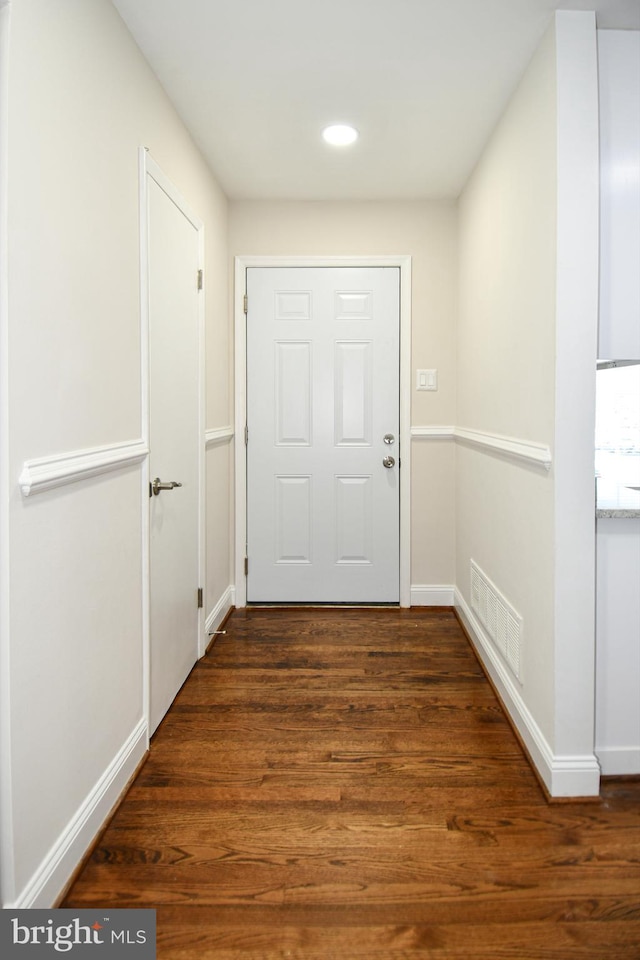 doorway to outside featuring dark wood-type flooring