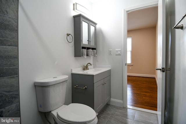 bathroom with tile patterned flooring, vanity, and toilet