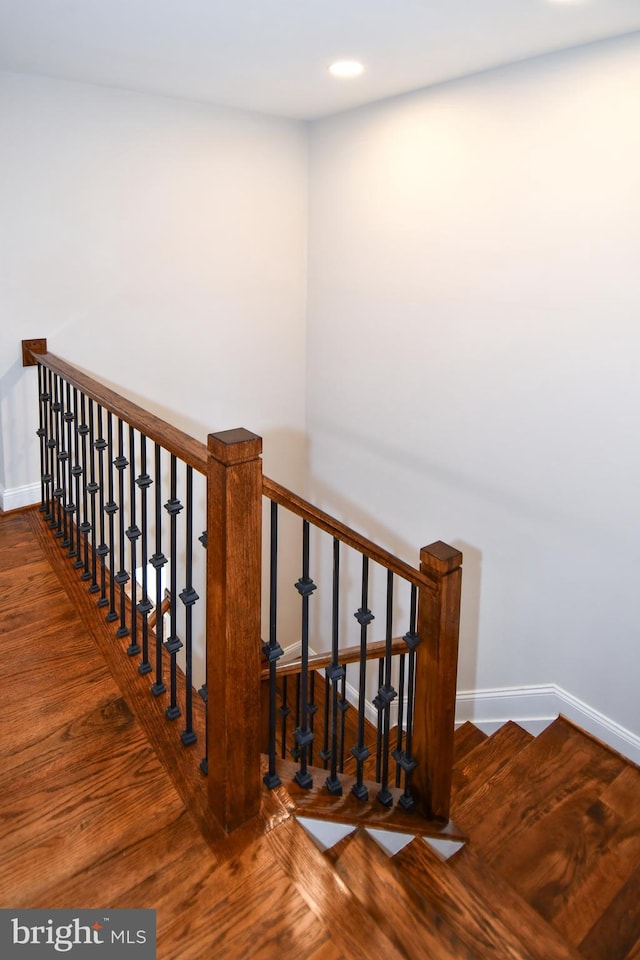 staircase with wood-type flooring