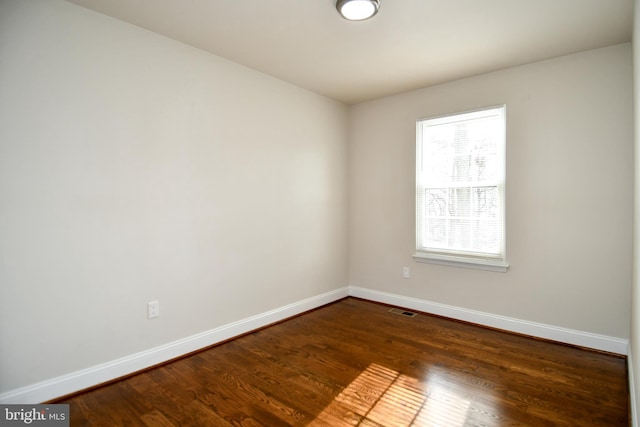 unfurnished room featuring dark hardwood / wood-style flooring