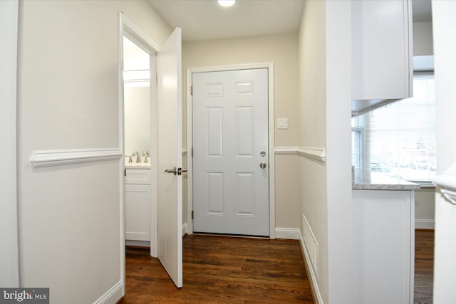 doorway to outside with dark hardwood / wood-style floors and sink