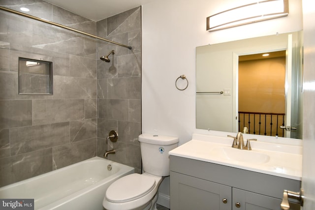 full bathroom featuring vanity, toilet, and tiled shower / bath