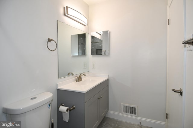 bathroom with tile patterned floors, vanity, and toilet