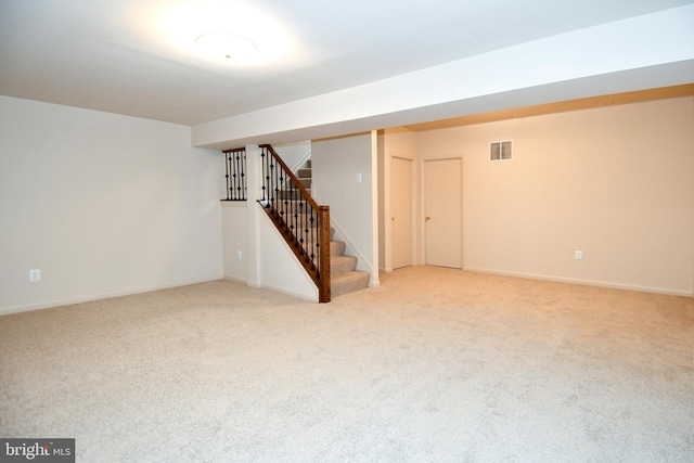 basement featuring light carpet