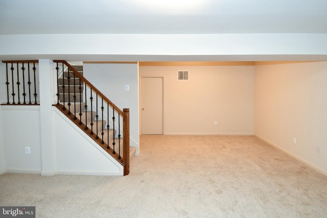 basement featuring light colored carpet