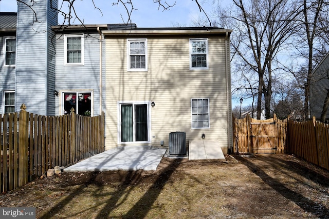 rear view of house featuring central air condition unit and a patio