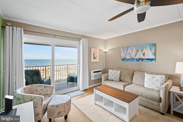 living room featuring ceiling fan, a wall mounted air conditioner, light hardwood / wood-style floors, a water view, and ornamental molding