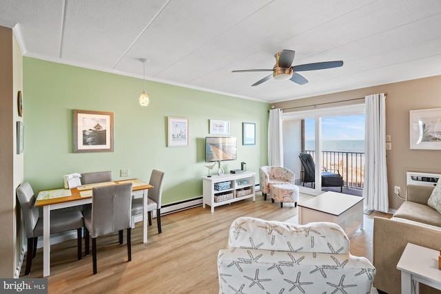 living room featuring baseboard heating, ceiling fan, crown molding, and light hardwood / wood-style floors