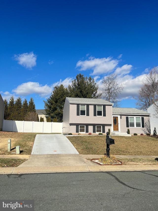 split level home featuring a front lawn