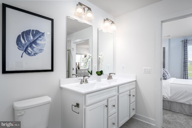 bathroom featuring toilet, vanity, and a wealth of natural light