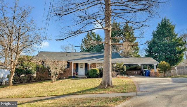 single story home featuring a front lawn and a carport