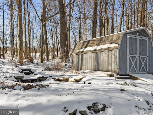 yard covered in snow with a storage shed