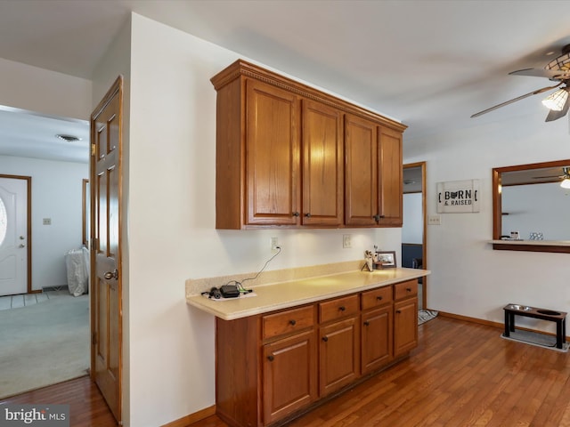 kitchen with ceiling fan and wood-type flooring