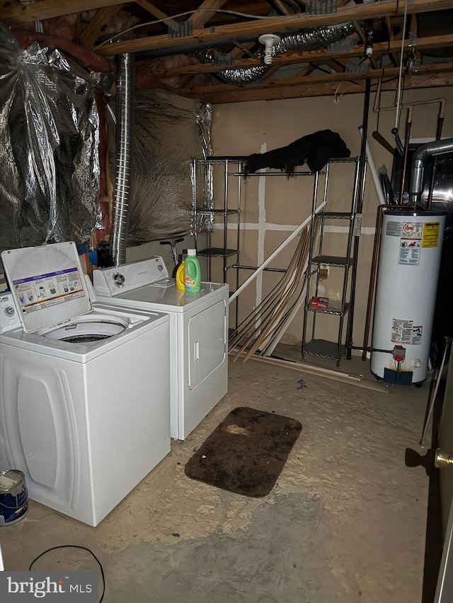 clothes washing area featuring independent washer and dryer and water heater