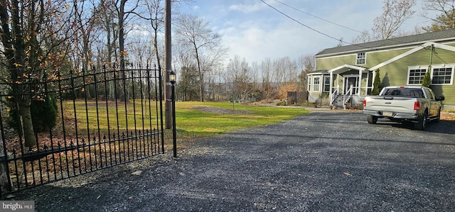 view of gate featuring a yard