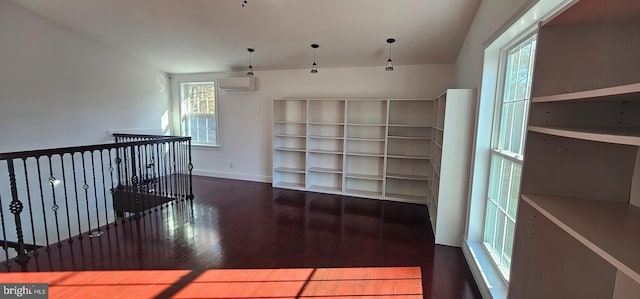 interior space featuring an AC wall unit and dark wood-type flooring