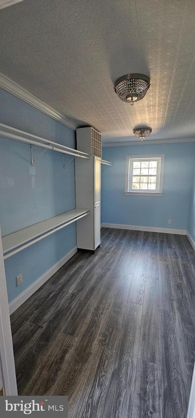 unfurnished bedroom with a textured ceiling, dark hardwood / wood-style floors, and crown molding