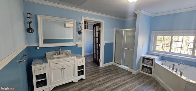 bathroom featuring hardwood / wood-style floors, vanity, crown molding, and plus walk in shower