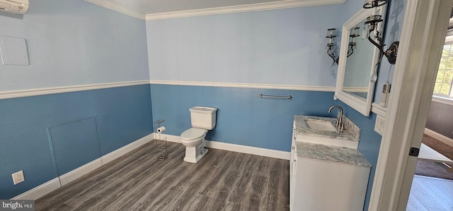 bathroom featuring vanity, a wall mounted AC, crown molding, hardwood / wood-style floors, and toilet