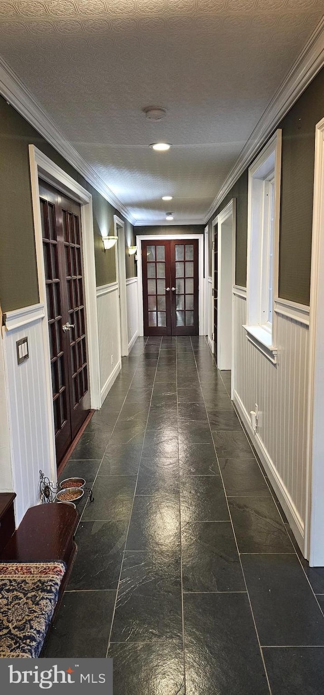 hall featuring french doors and ornamental molding