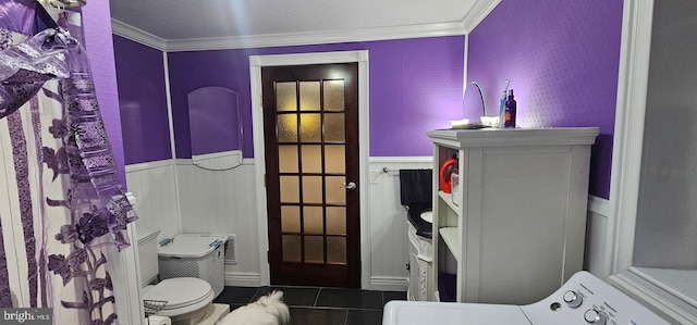 bathroom with tile patterned floors, washer / clothes dryer, toilet, and ornamental molding