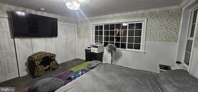 bedroom featuring a chandelier, dark colored carpet, a closet, and ornamental molding