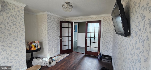 entrance foyer with french doors, dark wood-type flooring, and ornamental molding