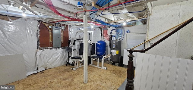 basement featuring electric panel and water heater